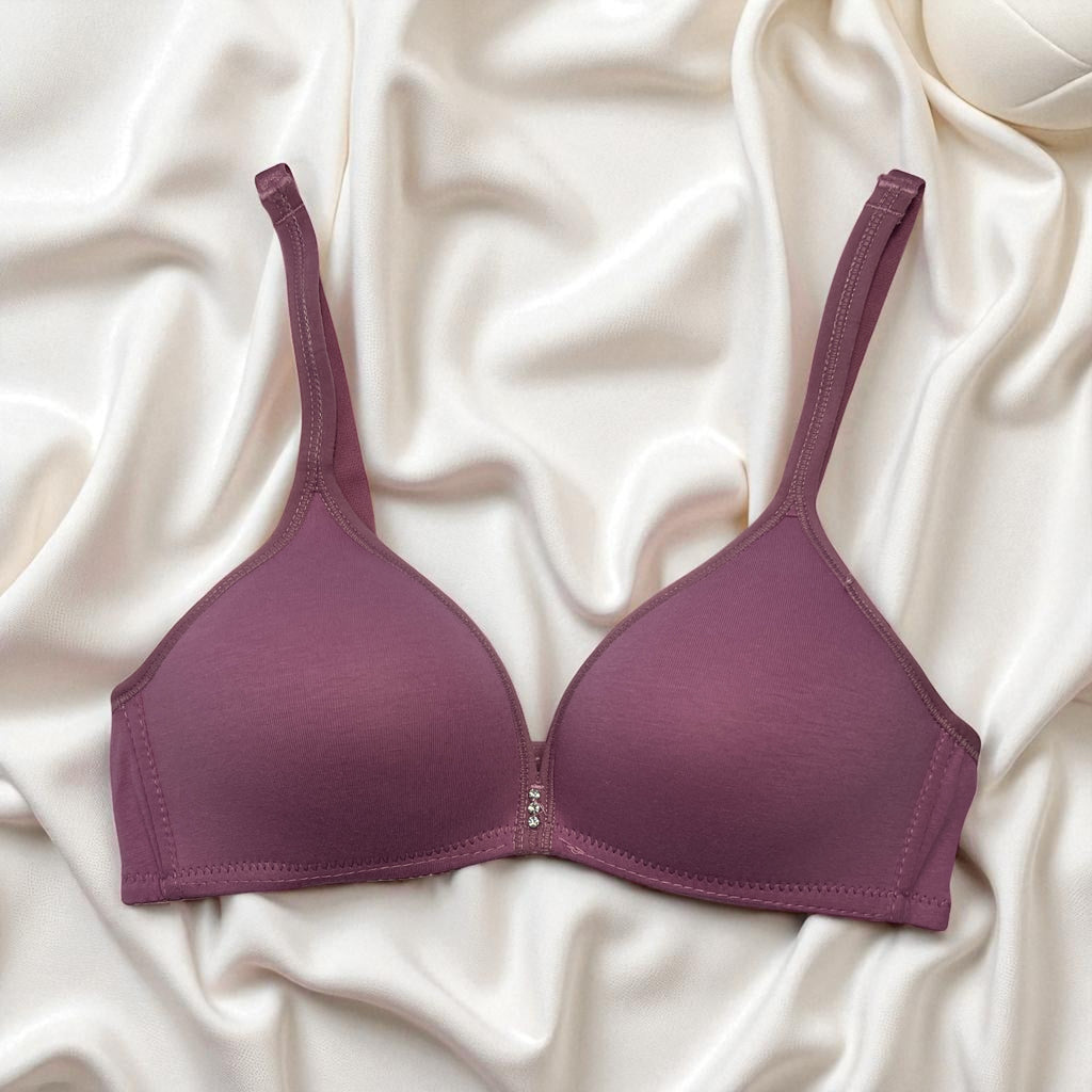 Purple bra on a white fabric background