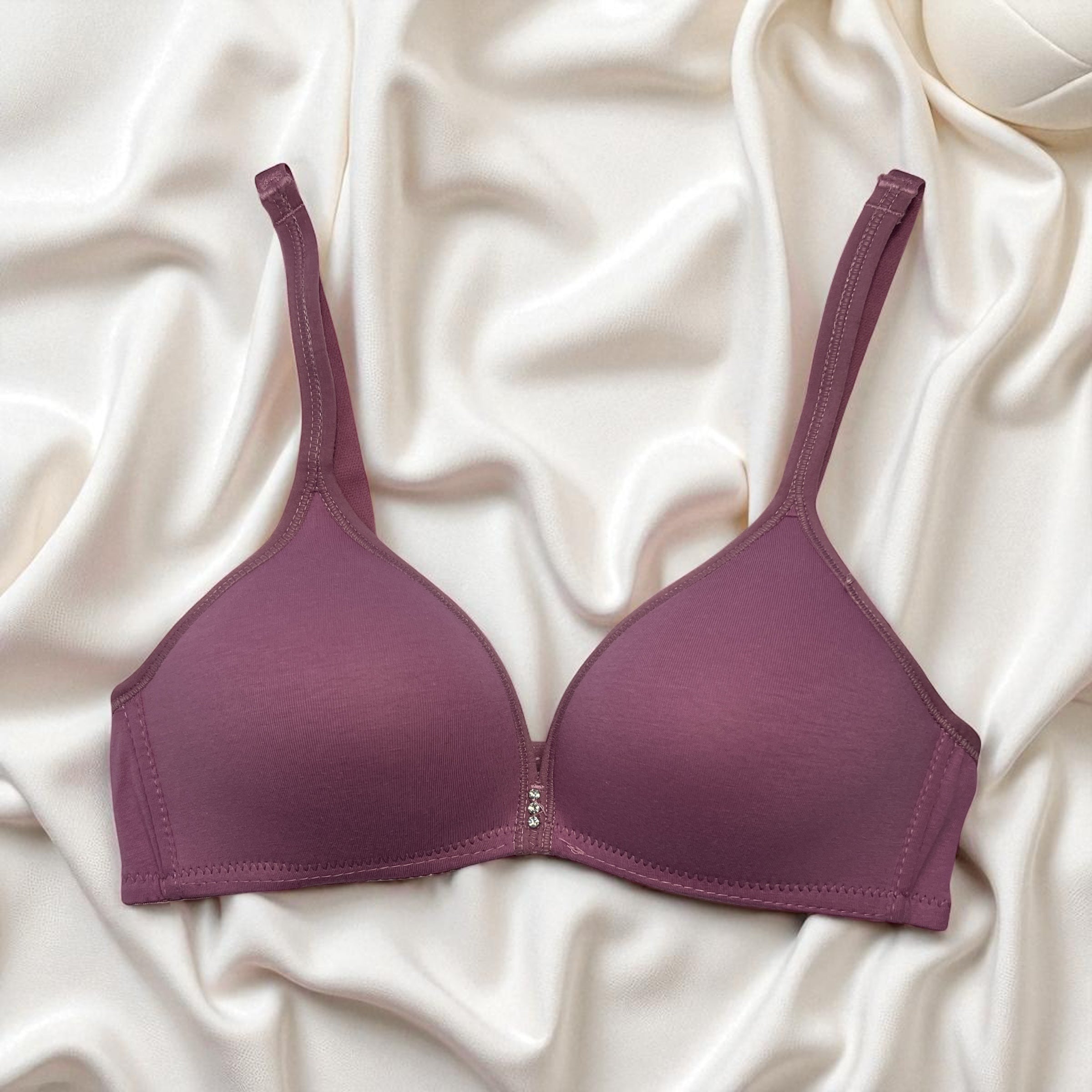 Purple bra on a white fabric background
